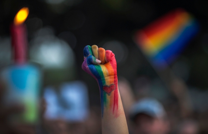 LOS ANGELES, CA - JUNE 13: A defiant fist is raised at a vigil for the worst mass shooing in United States history on June 13, 2016 in Los Angeles, United States. A gunman killed 49 people and wounded 53 others at a gay nightclub in Orlando, Florida early yesterday morning before suspect Omar Mateen also died on-scene.  (Photo by David McNew/Getty Images)